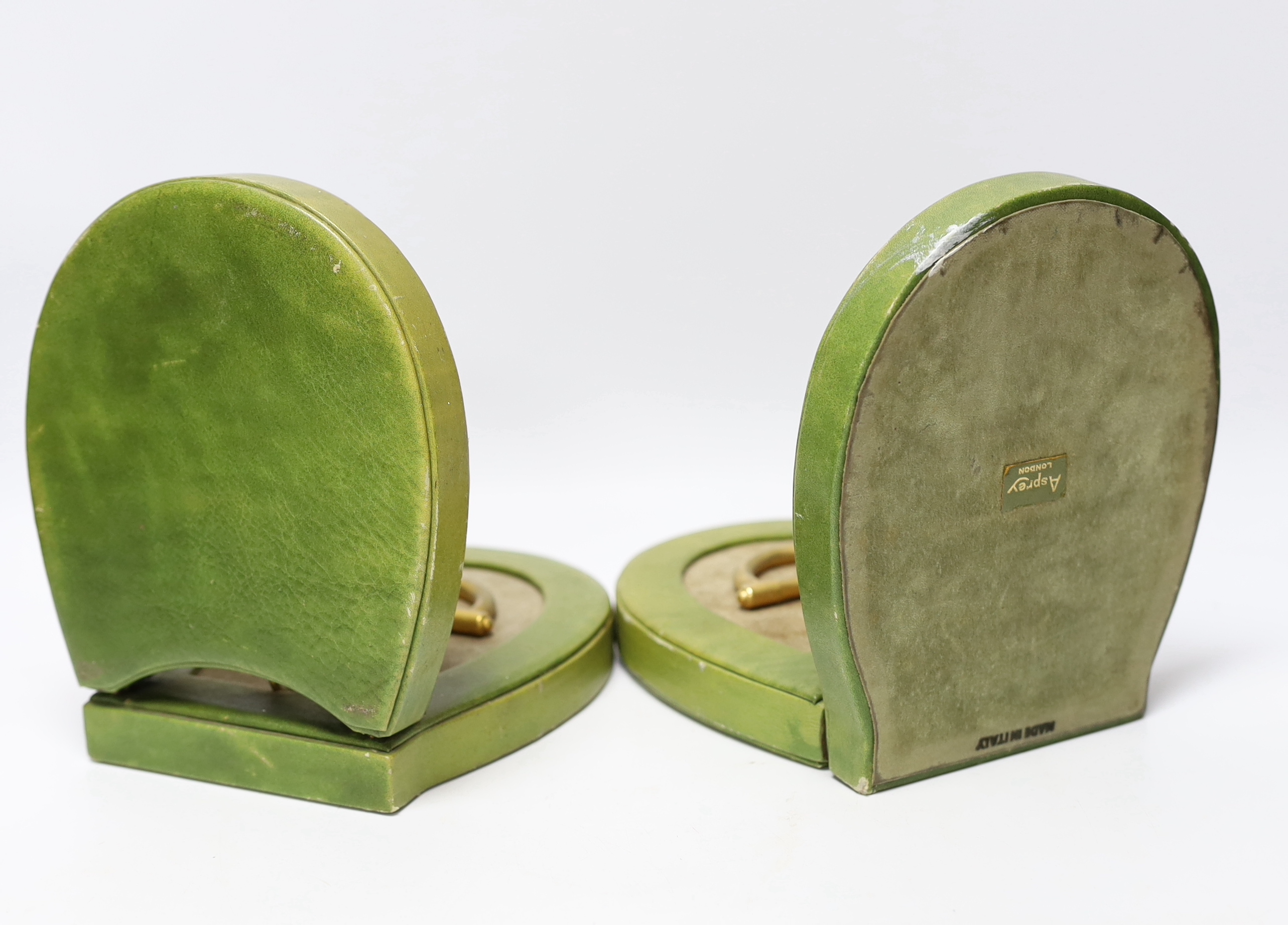 A pair of Asprey green leather and brass stirrup book-ends, 19.5cm